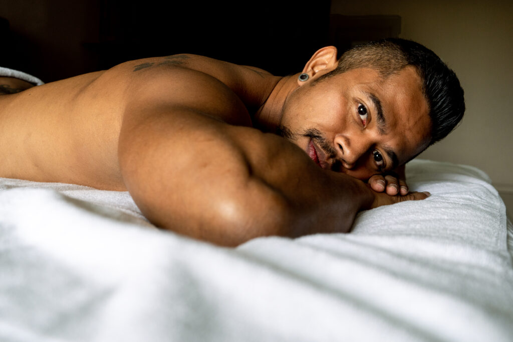 A muscular male client enjoying massage at Masotera Tokyo